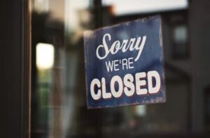 A "Sorry, We're Closed" Sign on a door