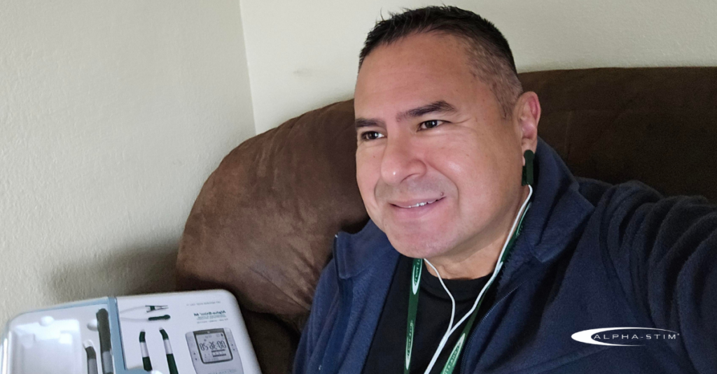 Veteran smiles after using Alpha-Stim to relieve back pain